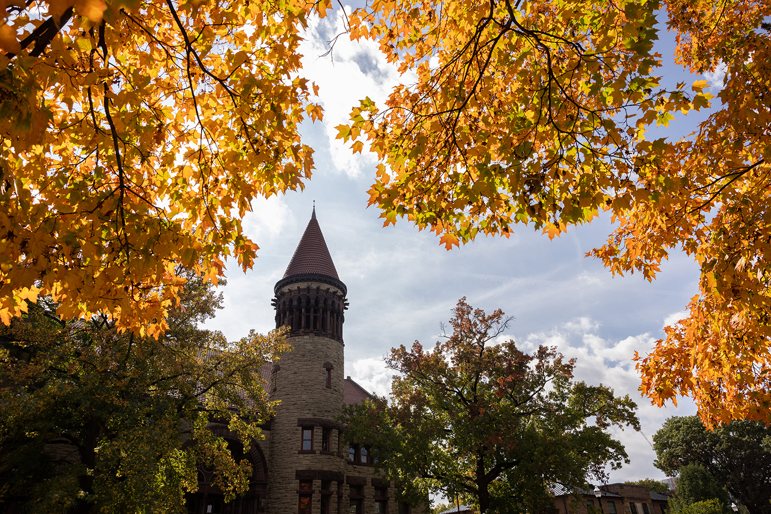 Orton Hall bell tower with yellow autumn foliage in the foreground