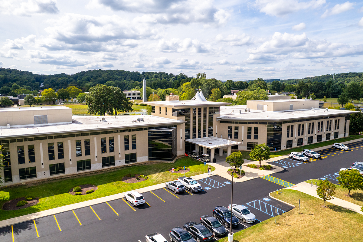 Aerial view of Ohio State Newark campus with white building and green hills