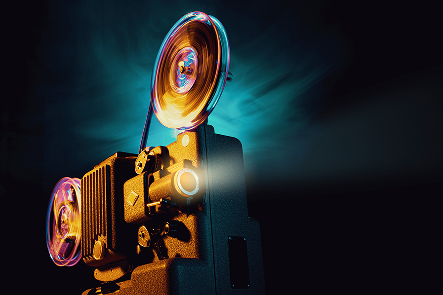 Film projector against a colorful background