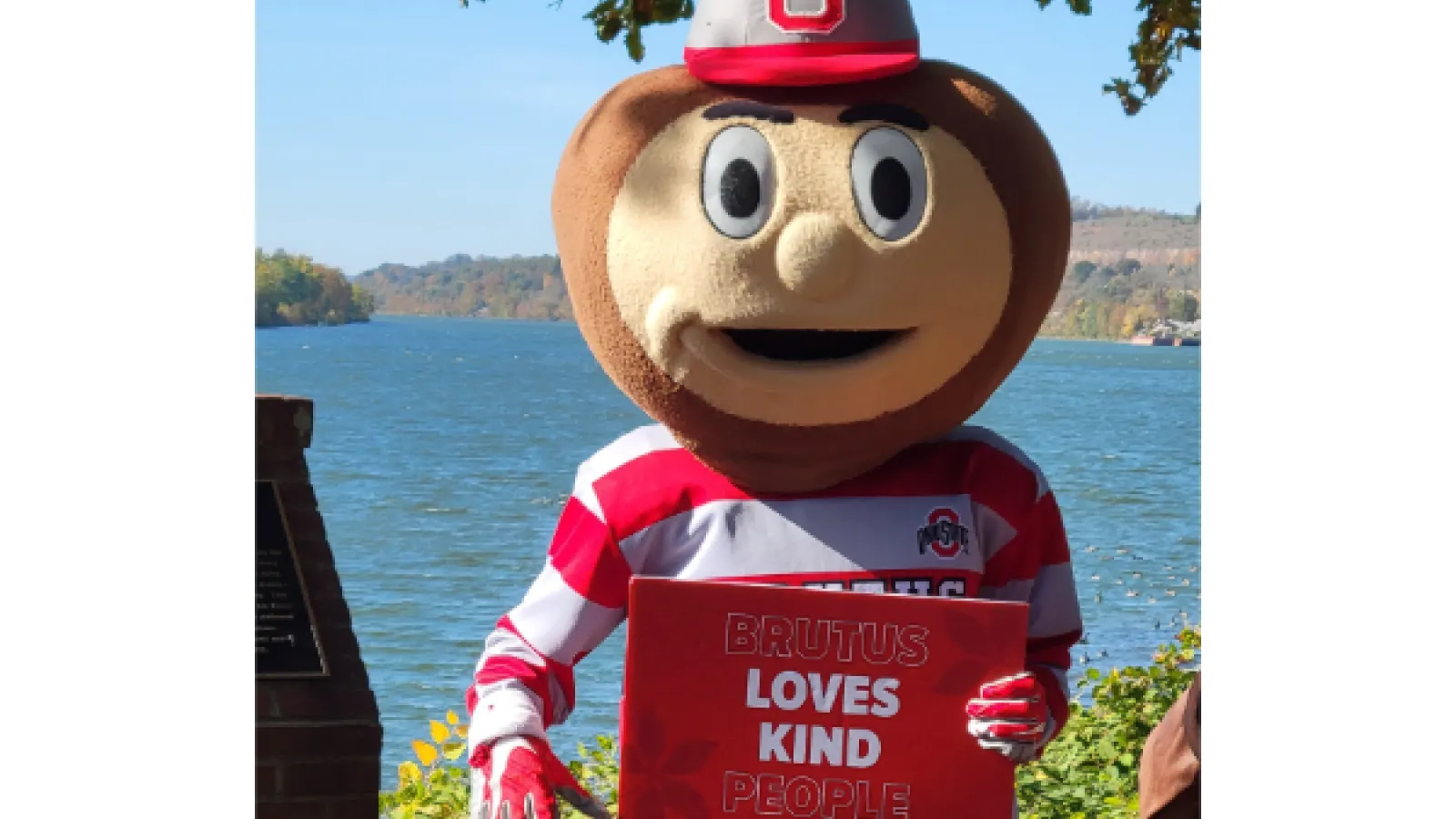 Brutus Holding a "Brutus loves kind people" sign