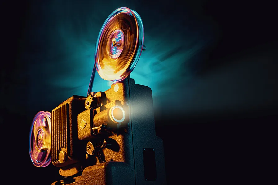 Film projector against a colorful background