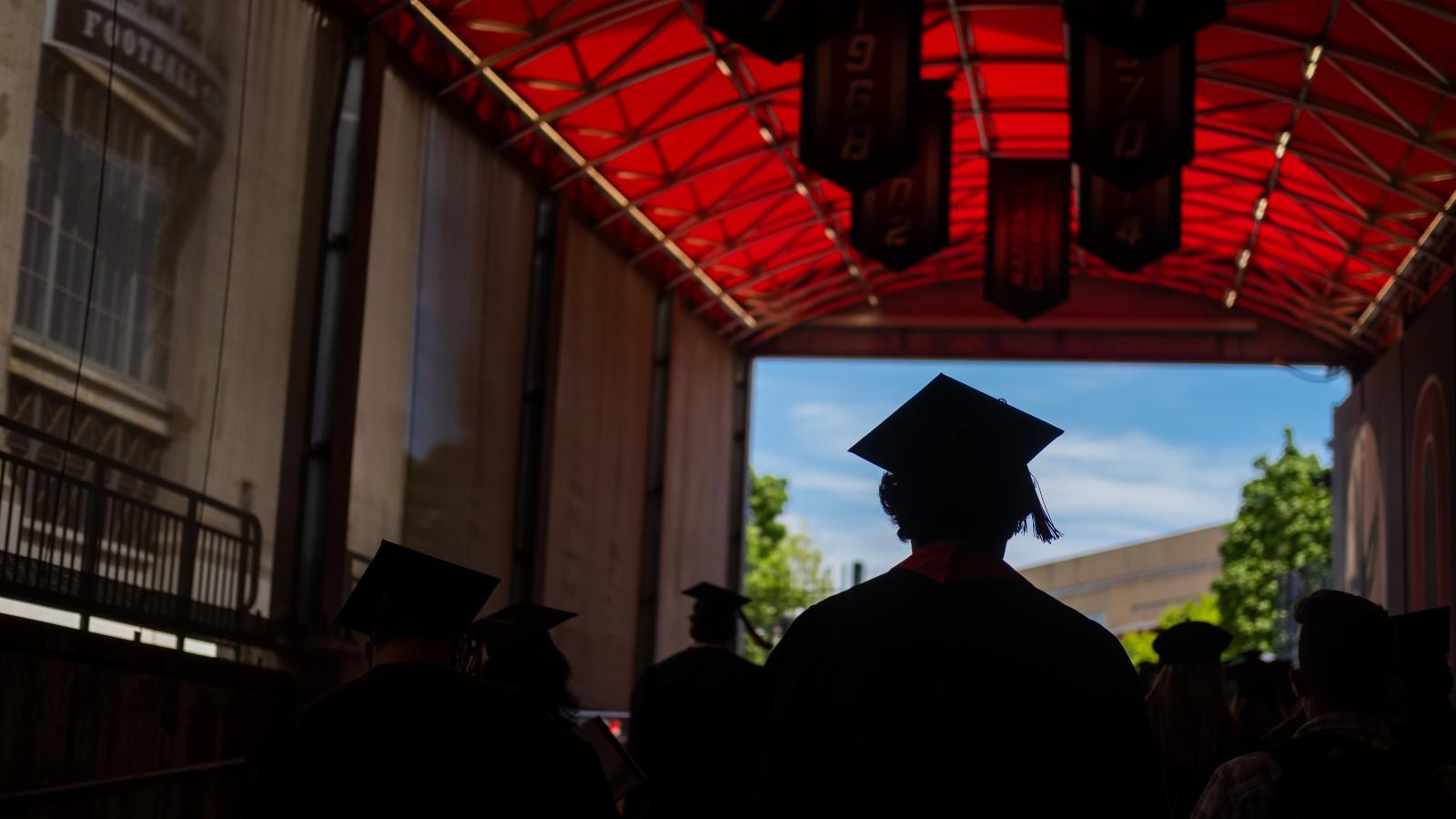 Graduating students walking into Ohio Stadium